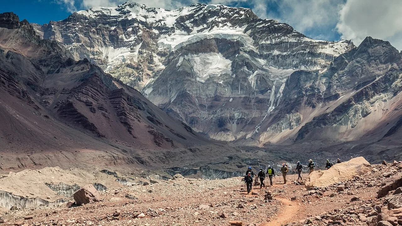 Trekkers approaching Aconcagua's snow-covered south face in Aconcagua Provincial Park